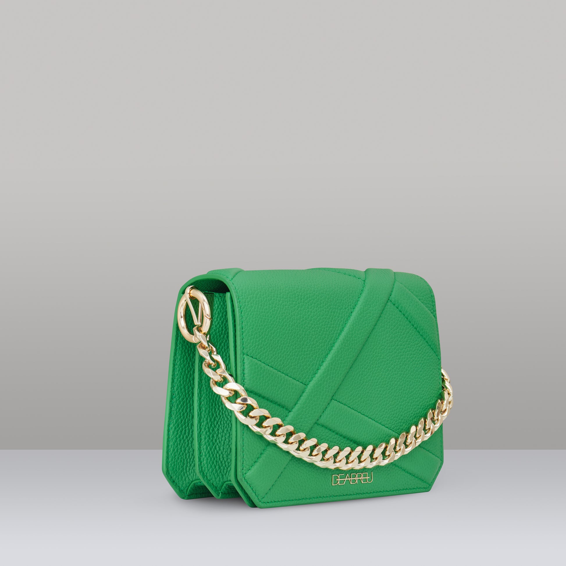Side view of green leather Cross Body Bag X-Line with gold metal chain and cotton strap