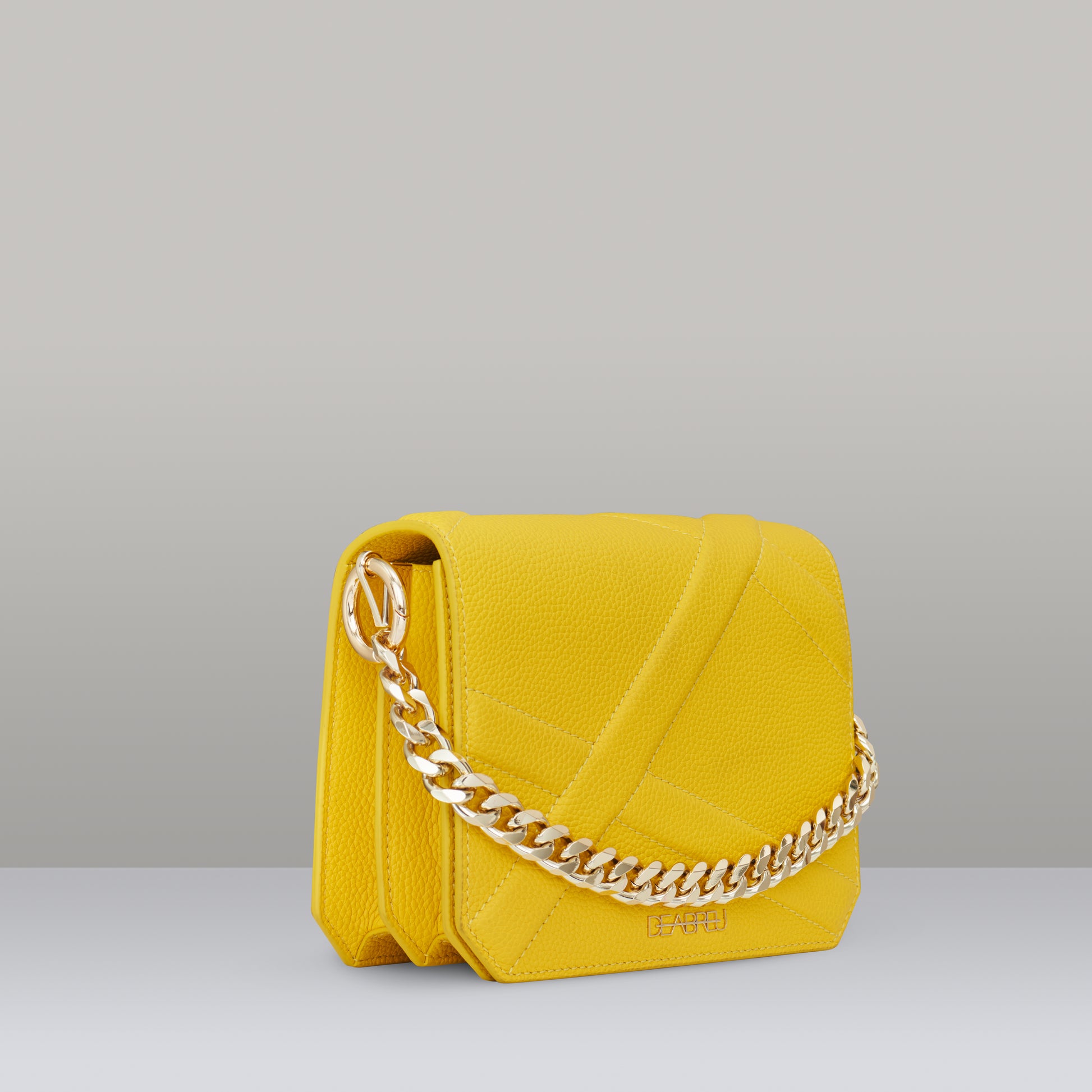 Side view of yellow leather Cross Body Bag X-Line with gold metal chain