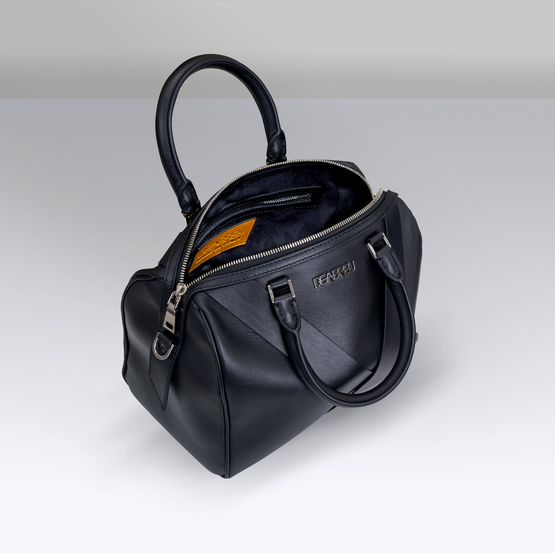 Interior of Deabreu Italy Black Calf Leather Boston Bag showing open top and lining