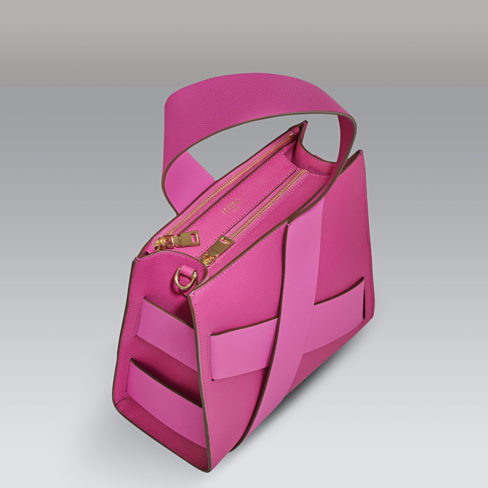 Side view of pink leather Diagonal Zita Bag with unique crossing straps