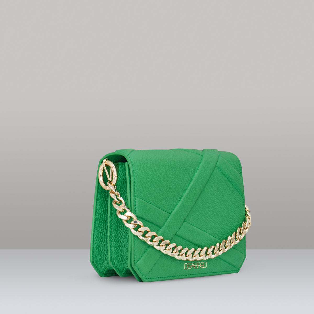 Side view of green leather Cross Body Bag X-Line with gold metal chain and cotton strap